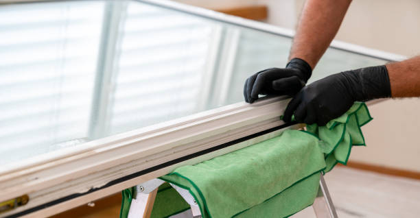 istock facility management cleaner cleaning a window and window frame with green micro fiber cloths 1226716538