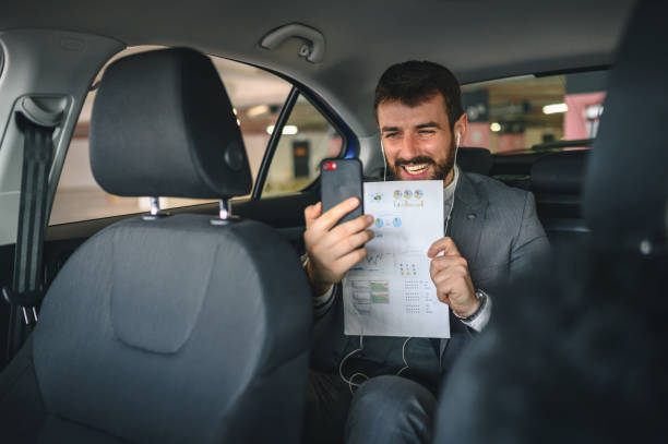 istock Businessman having video call while traveling in car 1226718750