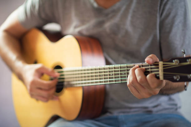 istock musician man playing acoustic guitar 1226718786