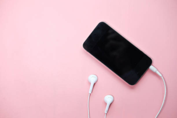 istock smart phone and earphone on pink background 1226721173