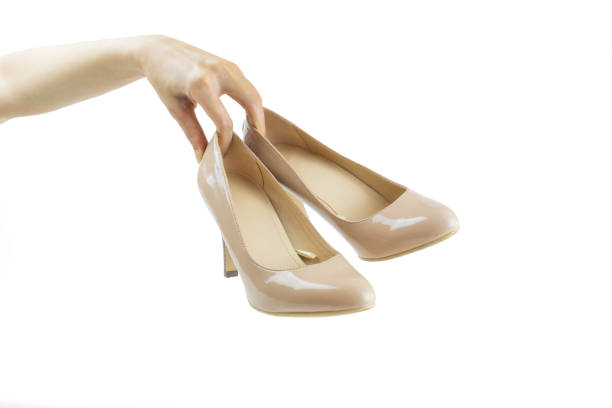 istock Hand holding  high heels on white background 1226722777