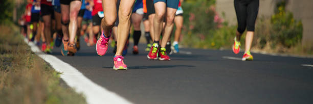 istock Marathon runners running on city road 1226723526