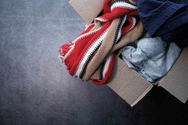 istock Donation box with donation clothes on a wooden table 1226723696