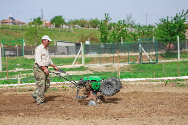 motor cultivator during plow process spring season gardening man concept