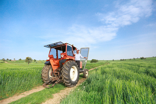 farmer standing in front of the tractor