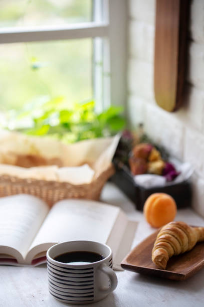 istock coffee, croissant and book on table 1226724110