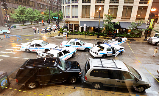 Chicago, Illinois, USA - August 27 - 2012: people looking at five police cars getting involved in a crash at crossroad between W Randolph st. and N Dearborn st. Chicago.