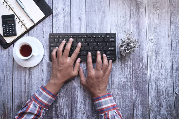 istock Top view of man hand typing keyboard on office desk 1226724988