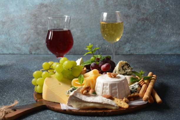 istock Cheese platter with assorted cheeses, grapes, nuts and snacks . Italian, French cheese starter. Traditional Shavuot Jewish Holiday food concept 1226726947