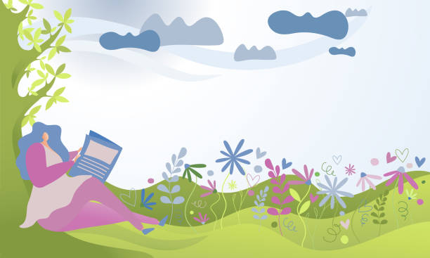 istock A woman sitting on the grass and reading newspaper. 1226727538