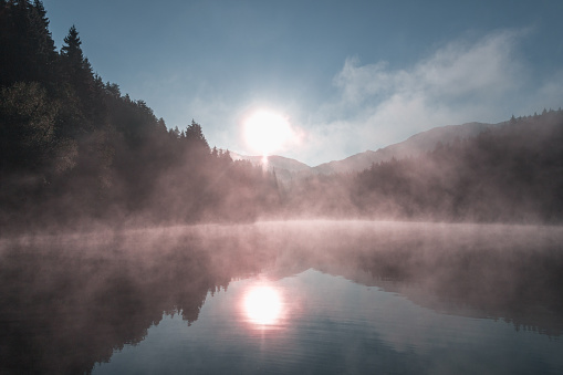 The golden light of the sun on the water surface of the lake. \nPerspiration on the water in the sun light