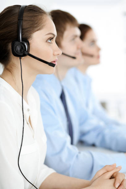 istock Call center. Diverse customer service operators in headsets at work in office. Business concept. 1226733636