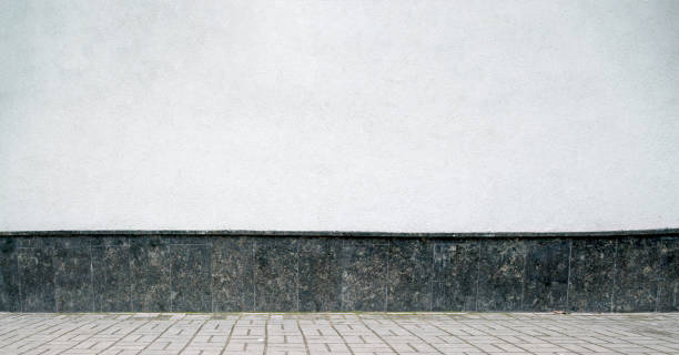 istock paved sidewalk covered with stone tiles by building with white wall on sunny day 1226735581