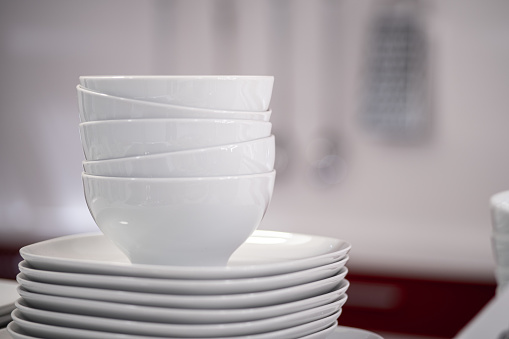 white plates bowls with blurred background at the kitchen