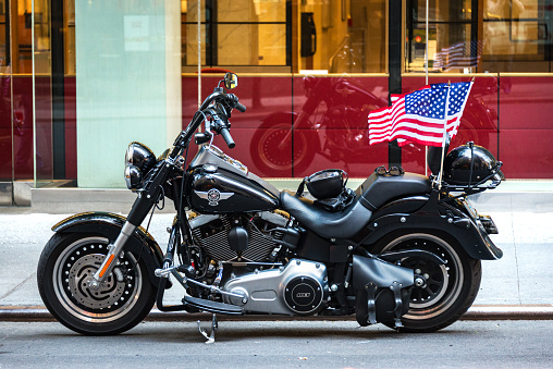 Black vintage Harley Davidson motorbike parked in downtown Manhattan, New York City.