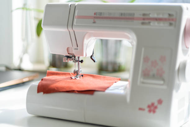 istock Sewing machine on the white table in fron of the window 1226738700