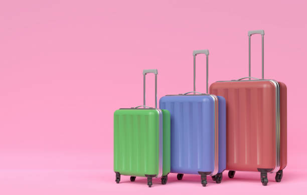 istock Three multi-colored travel suitcases of different sizes on a pink background. 3D illustration 1226739323