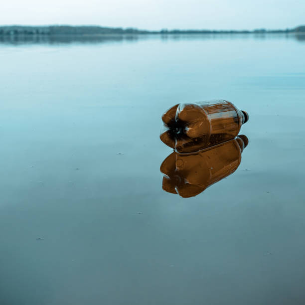 istock Environmental pollution. Waste rubbish in environment and water. Sea plastic garbage trash on marine ocean beach. Ecological problem with Empty used dirty plastic bottles. 1226741783