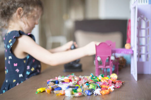 istock girl playing with toys and candy sugar 1226743055