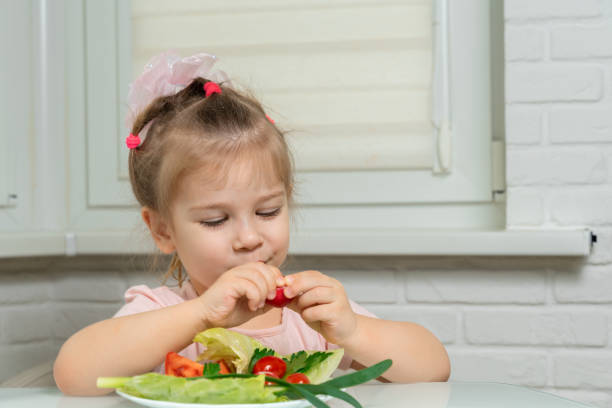 istock little girl eats vegetables 1226744759