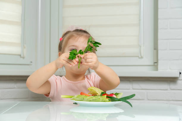 istock little girl eats vegetables 1226744780