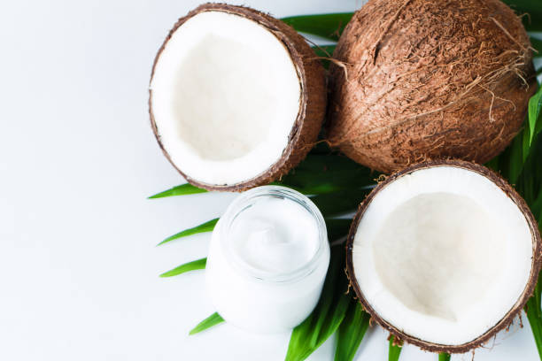 istock Ripe half cut coconut with green leaves on a white background. Isolated concept. 1226744781