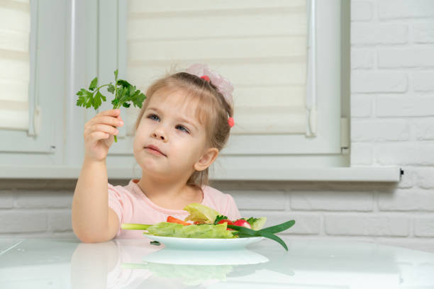 istock little girl eats vegetables 1226744786