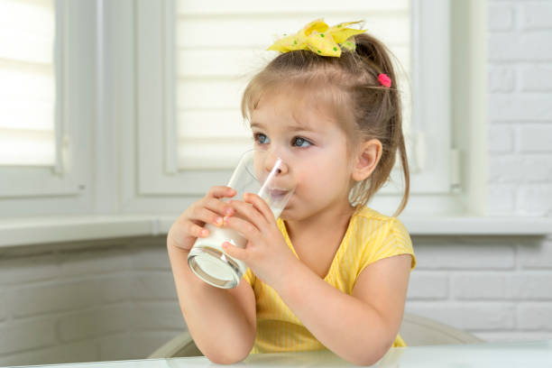 istock little girl drinks milk 1226745416