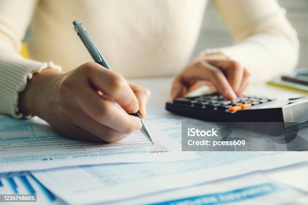 Closeup Woman Filling Form Of Individual Income Tax Return Stock Photo - Download Image Now