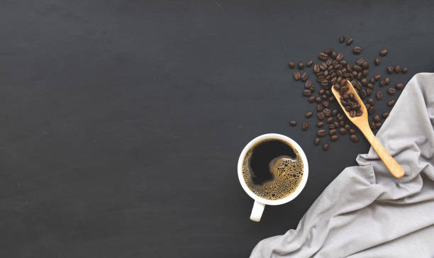 istock cup of coffee on black wooden floor background. top view. space for text 1226749736