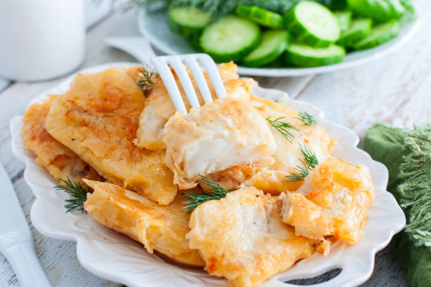 pollock fillet in batter on a white plate, selective focus - pollock trawler imagens e fotografias de stock