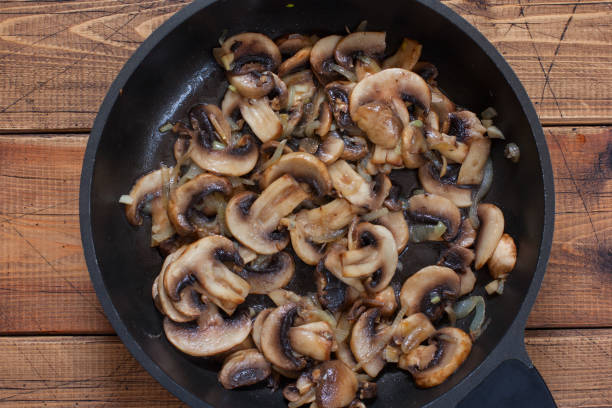 istock Step-by-step preparation of planers with chicken and mushrooms, step 3 - fried champignons in a pan, top view, selective focus 1226752369