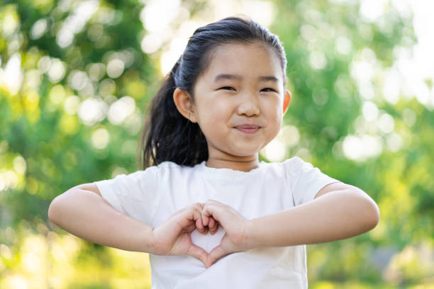 istock Little Girl Making Heart Shaped Gesture 1226753289
