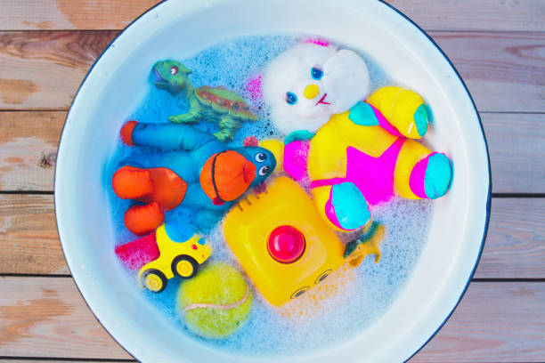 istock washing various toys with soap and water to disinfect them 1226753620