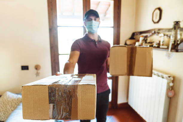 istock messenger delivering a box during the covid19 1226755432