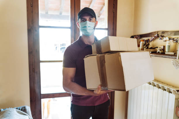 istock messenger delivering a box during the covid19 1226756050