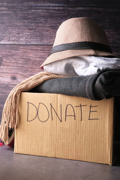 istock Donation box with donation clothes on a wooden table 1226756077