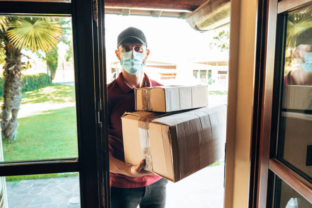 istock messenger delivering a box during the covid19 1226756086