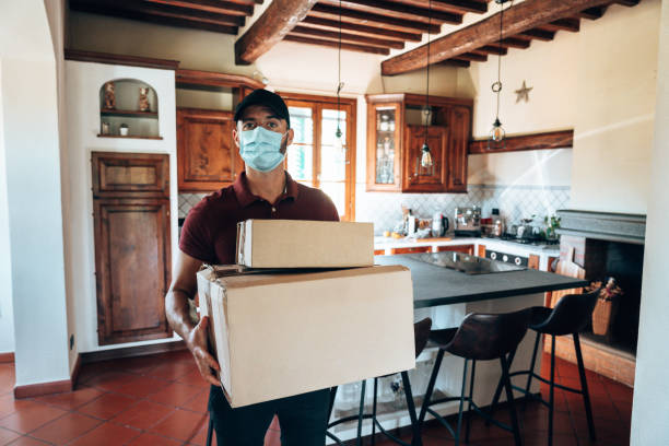 istock messenger delivering a box during the covid19 1226756159