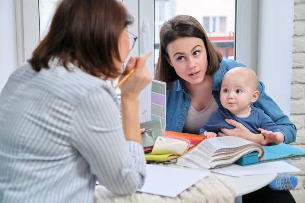 istock Women interior designer and client with baby choosing fabrics and materials 1226756230