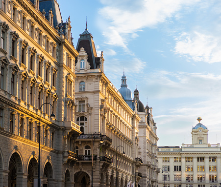 Vienna, Austria - May 29, 2020: The buildings along Lichtenfelsgasse in Vienna are lit by the setting sun. Viennese  City Hall is opposite these buildings.