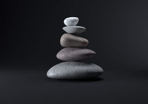 Digitally generated image balancing smooth stones in a studio environment on a black background.