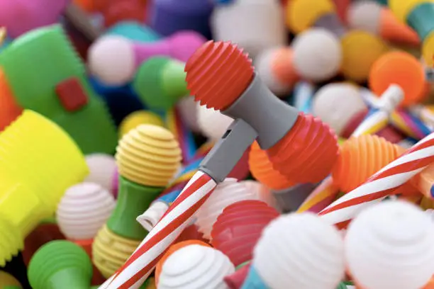 Photo of Bright multicoloured plastic toy hammers and bunting for celebrating the feast of St. John the Baptist in Porto, Portugal