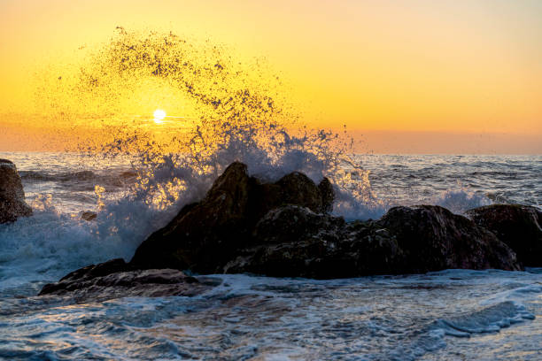 Waves of the Atlantic Ocean crashing against a rock at sunset. Seascape in Portugal, Miramar near Porto stock photo