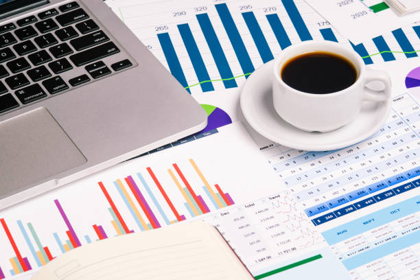 istock Open laptop, a Cup of coffee, and statistical graphs on the desktop. Work as an analyst, marketer, or financier. Business concept, investment and accounting. 1226758813