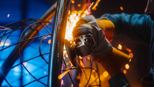 istock Close Up of a Talented Innovative Artist Using an Angle Grinder to Make an Abstract, Brutal and Expressive Metal Sculpture in a Workshop. Contemporary Fabricator Creating Modern Steel Art. 1226760218