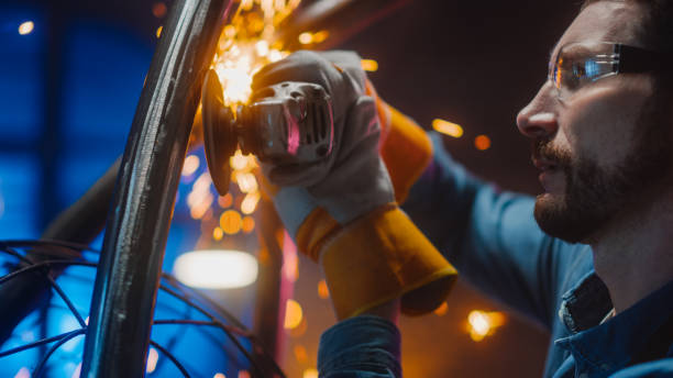 istock Close Up of a Talented Innovative Artist Using an Angle Grinder to Make an Abstract, Brutal and Expressive Metal Sculpture in a Workshop. Contemporary Fabricator Creating Modern Steel Art. 1226760252