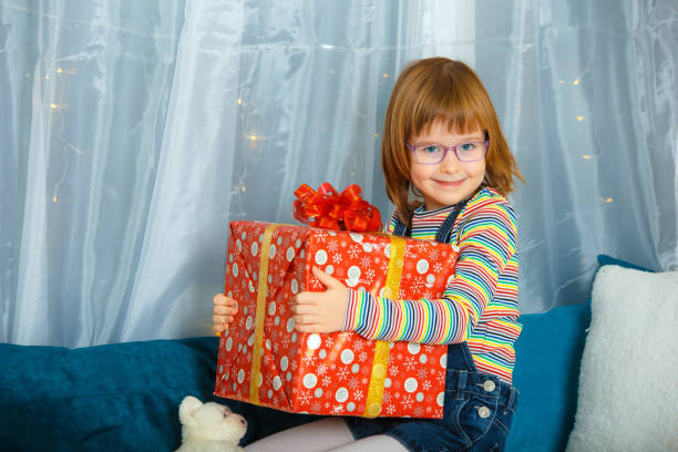 istock Girl Masha holding a box with a gift. 1226762035