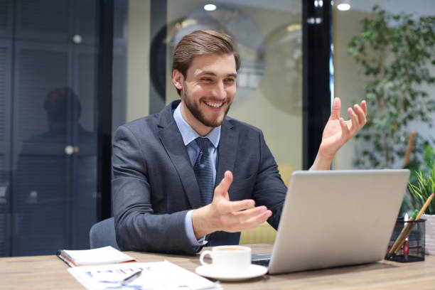 istock Smiling young business man having video call in office. 1226762100