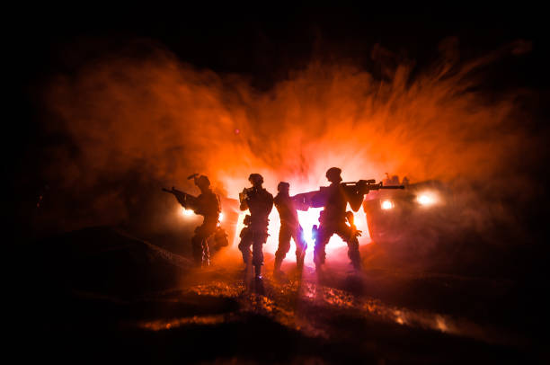 istock War Concept. Battle scene on war fog sky background, Fighting silhouettes Below Cloudy Skyline at night. 1226762169